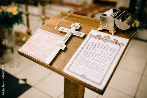 Cross and Bible on a wooden shelf
