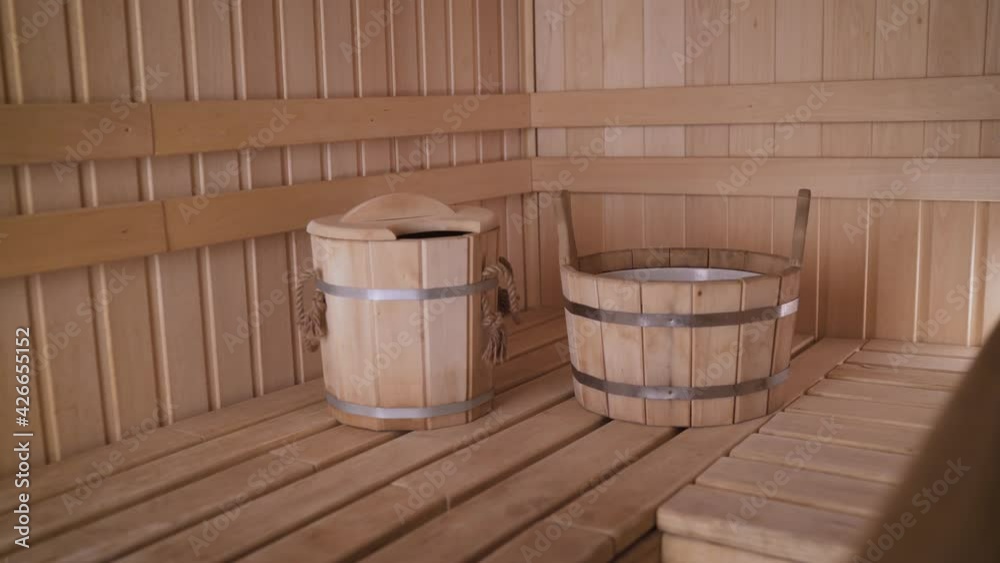 Sauna with wooden sinks. Interior details Finnish sauna steam room with traditional sauna accessories. Sauna with wooden sinks. Interior details Finnish sauna steam room with traditional sauna accessories.