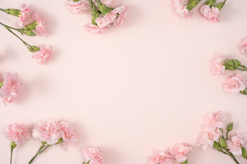 Design concept of Mother's day holiday greeting with carnation bouquet on pink table background
