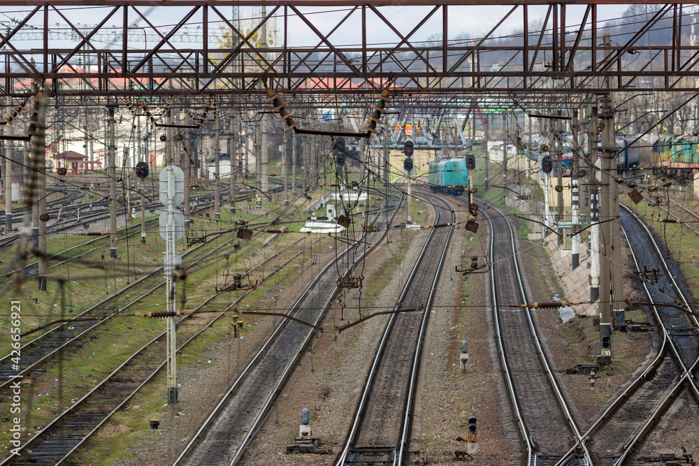 Many railway tracks, semaphores, poles, wires and other devices at a large railway station.