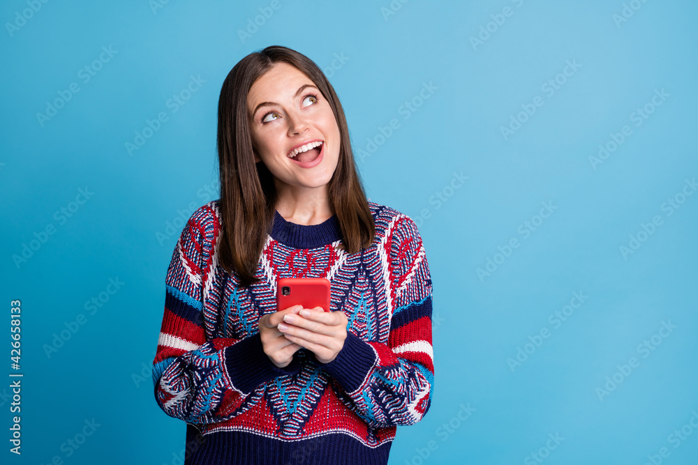Fototapeta premium Photo portrait girl keeping cellphone browsing internet looking copyspace isolated vivid blue color background