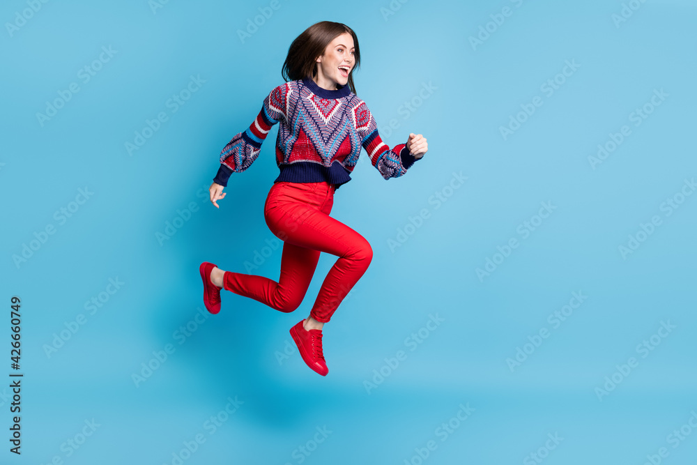Full length body size view of attractive cheerful girl jumping running active life isolated over bright blue color background Full length body size view of attractive cheerful girl jumping running active life isolated over bright blue color background