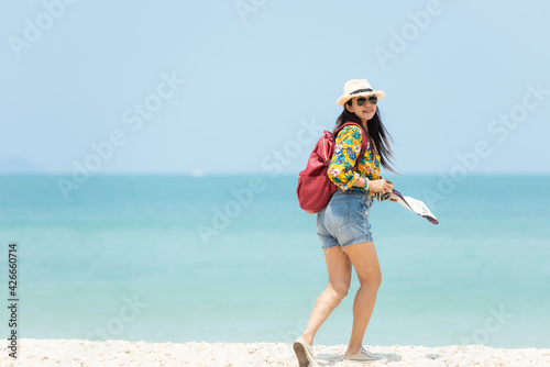 Happy traveler and tourism women travel summer on the beach.  Asia smiling people holding map and camera planning travel trip and relax outdoor for destination and leisure.
