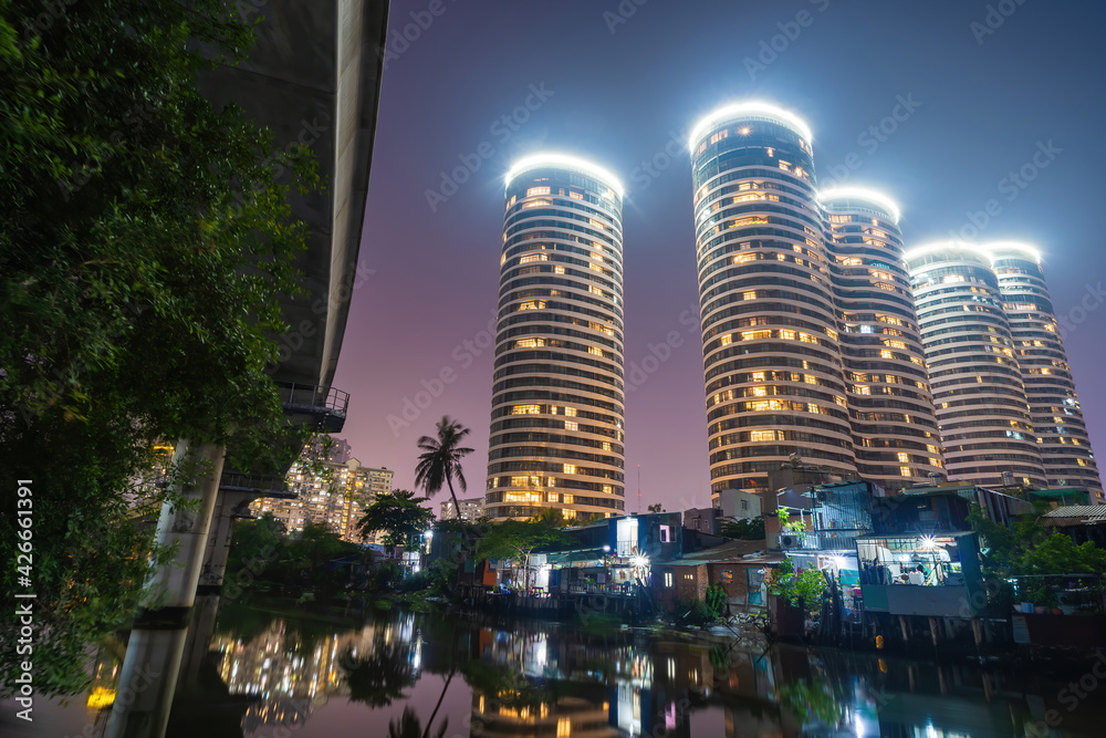 A contrast scene between new modern buildings and slums in developing countries like Vietnam. A landscape represents a reflection between rich and poor A contrast scene between new modern buildings and slums in developing countries like Vietnam. A landscape represents a reflection between rich and poor