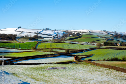 Snow on colourful green and white Shropshire Hills, near Clun, in December for Christmas. Beautiful hilly British landscape, England, UK, stock photo photo