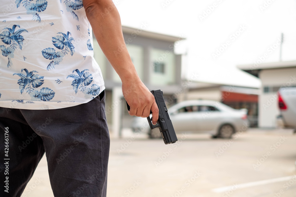 man holding an automatic shotgun, with blurred nature background at khon kaen ,Thailand on 9 april 2021
