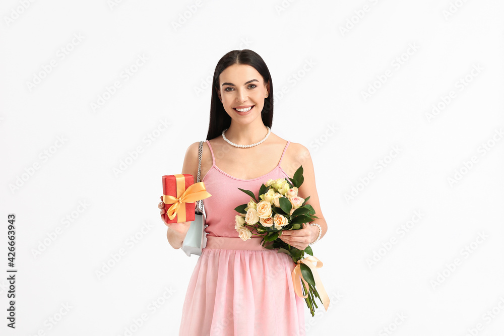 Beautiful woman with flowers and gift on white background. International Women's Day celebration Beautiful woman with flowers and gift on white background. International Women's Day celebration