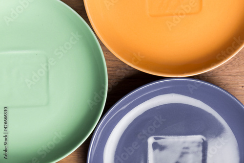 closeup of a composition with a tableware, part of a set of round colored plates