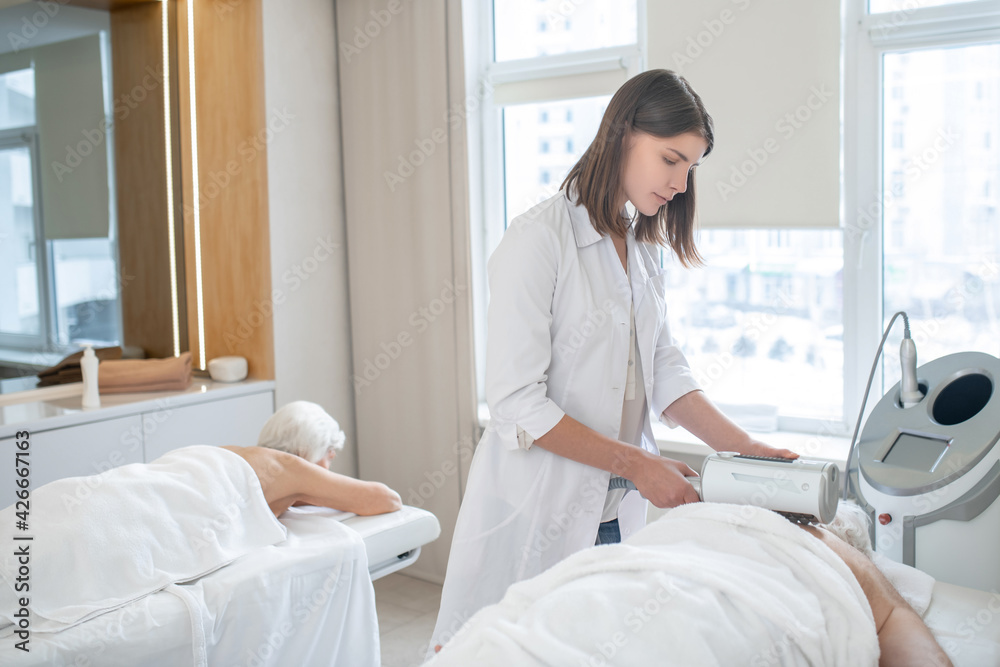 Physiotherapist working with a female patient in a rehabilitation center Physiotherapist working with a female patient in a rehabilitation center