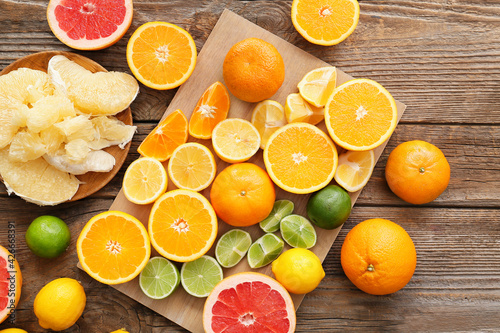 Fresh citrus fruits on wooden background