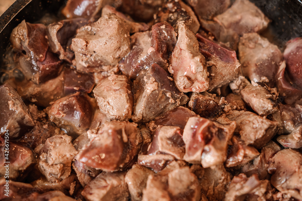 Fried veal liver in a pan. Braised cow and pork liver Fried veal liver in a pan. Braised cow and pork liver