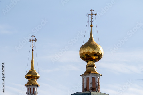 Golden domes of a church temple against a blue sky