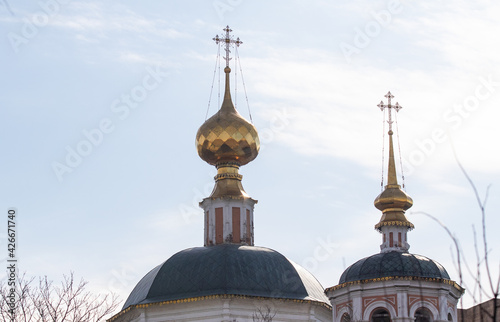 Golden domes of a church temple against a blue sky