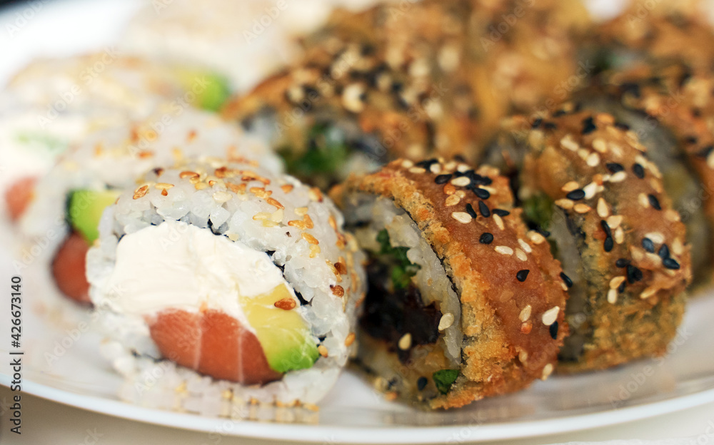 Plate with tasty sushi rolls. Home food delivery. Plate with tasty sushi rolls. Home food delivery.