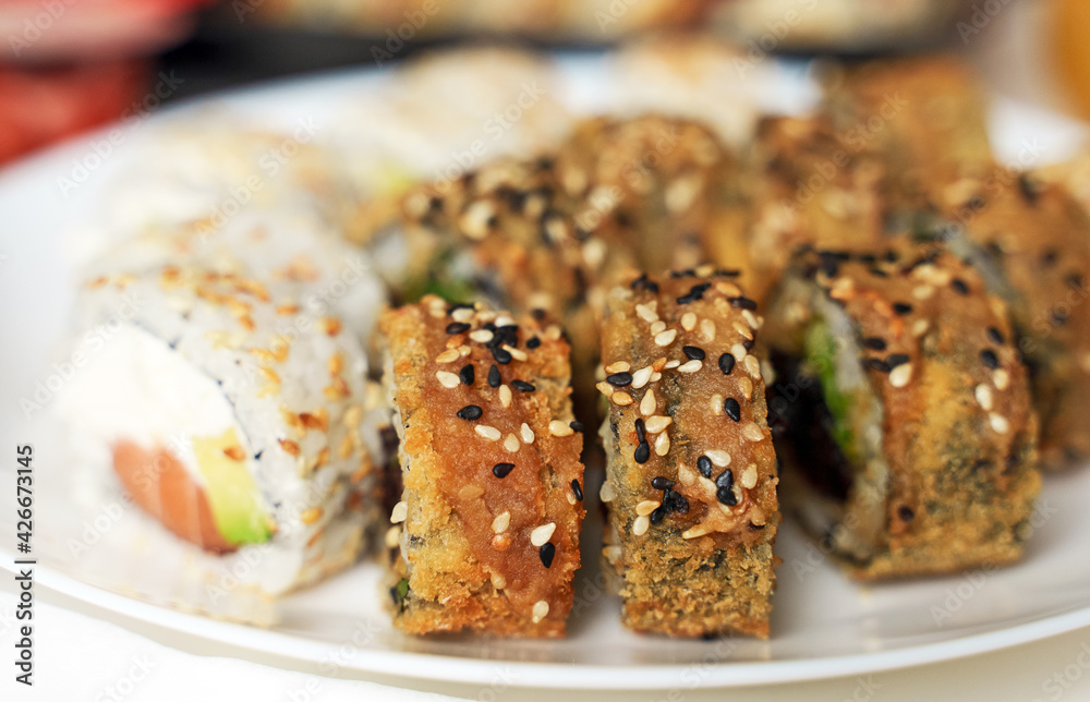 Plate with tasty sushi rolls. Home food delivery. Plate with tasty sushi rolls. Home food delivery.