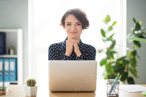 Portrait of attractive cheerful smart skilled girl expert browsing web report researching data workplace workstation indoors © deagreez