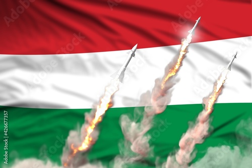 Modern strategic rocket forces concept on flag fabric background, Hungary nuclear warhead attack - military industrial 3D illustration, nuke with flag photo