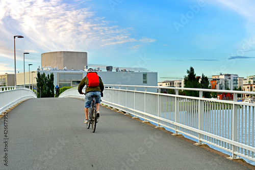 Cyclists on bridge across river Oulujoki. Oulu, Suomi photo