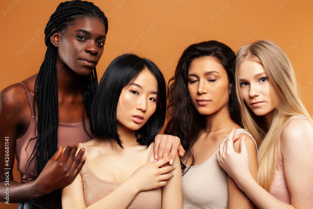 young pretty asian, caucasian, afro woman posing cheerful together on brown background, lifestyle diverse nationality people concept young pretty asian, caucasian, afro woman posing cheerful together on brown background, lifestyle diverse nationality people concept
