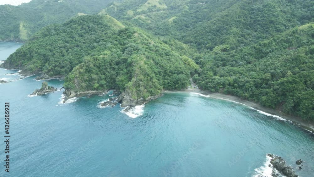 Amazing aerial of a coastal black sand beach with mountains as the backdrop on the Caribbean island of Tobago Amazing aerial of a coastal black sand beach with mountains as the backdrop on the Caribbean island of Tobago