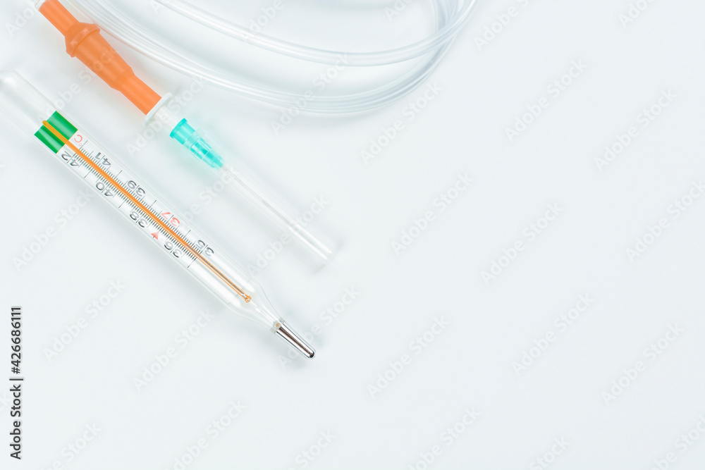 Dropper with mercury thermometer on white background. Concept of treatment and health.