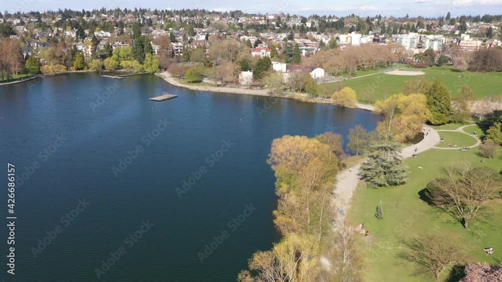 Cinematic aerial drone flyover shot of Green Lake Park with its running walking biking roller skating trail with nearby Wallingford, Woodland Park, Meridian, Phinney Ridge in Seattle, Washington Cinematic aerial drone flyover shot of Green Lake Park with its running walking biking roller skating trail with nearby Wallingford, Woodland Park, Meridian, Phinney Ridge in Seattle, Washington