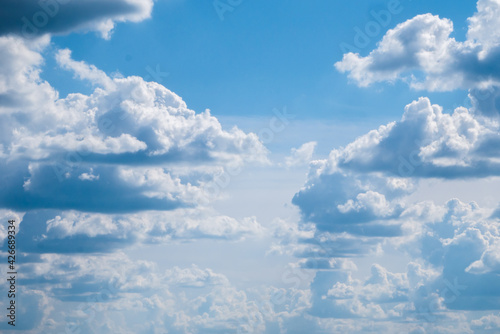 Fototapeta Naklejka Na Ścianę i Meble -  Beautiful blue sky with big fluffy clouds. The horizon is covered with gray haze