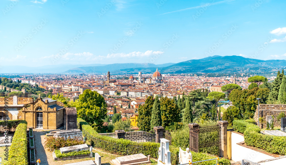 Scenic view of Florence from the Basilica of San Miniato al Monte, near Piazzale Michelangelo. Blue sky and vegetation; Tuscany region, Italy.