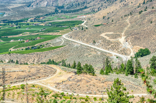 Landscape with orchard farms at Okanagan lake on hot summer day