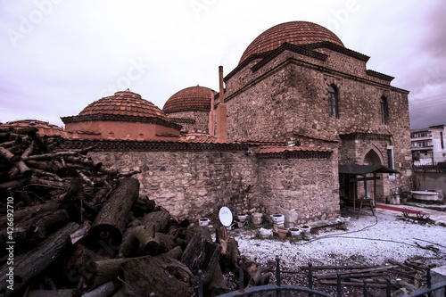 Fotografi Wide angle view of a Turkish bath at Iznik, with a large pile of wood in the front yard waiting to be burned