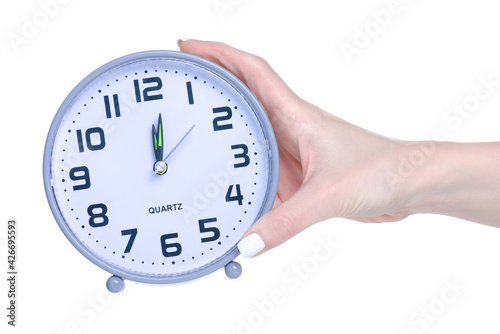 Table clock alarm clock in hand on white background isolation