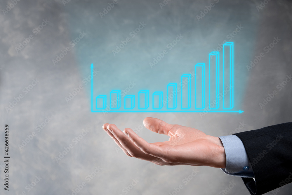 Businessman holding graph growth and increase of chart positive indicators in his business.Investment up concept.analyzing sales data and economic,strategy and planning, Digital marketing and stock Businessman holding graph growth and increase of chart positive indicators in his business.Investment up concept.analyzing sales data and economic,strategy and planning, Digital marketing and stock