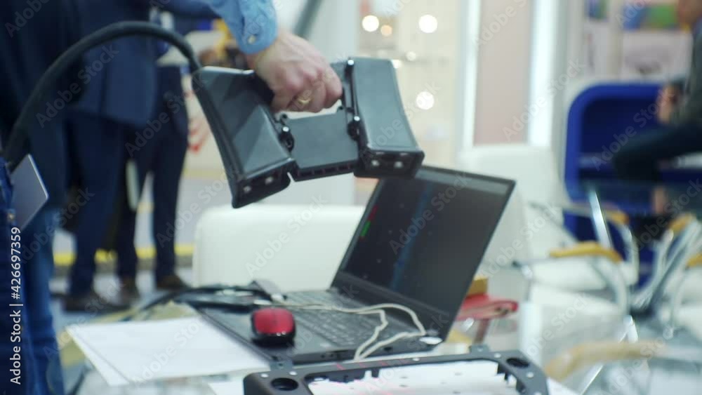 unrecognizable man working with modern technological equipment in a large bright room. blurred background on a business theme. unrecognizable man working with modern technological equipment in a large bright room. blurred background on a business theme.