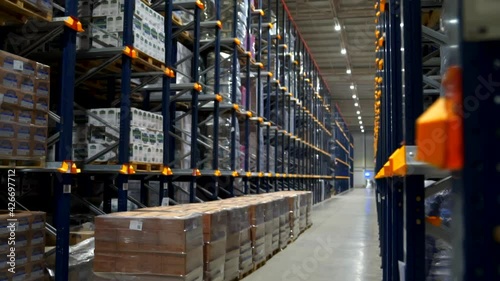 View on the endless industry racks with a food product boxes folded at factory storage of transport department