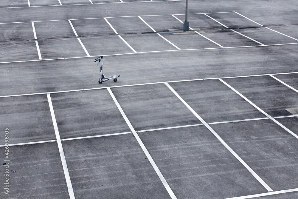 Empty airport parking with baggage trolley during lockdown of corona crisis