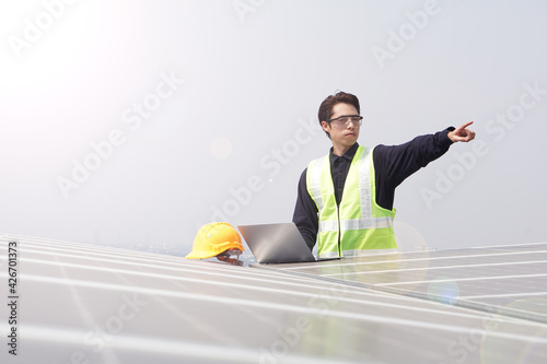 Asian engineer for solar panel inspection roof construction.