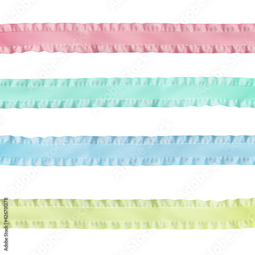 rep ribbon with ruffles isolated on a white background in four colors: pink, blue, green, yellow photo