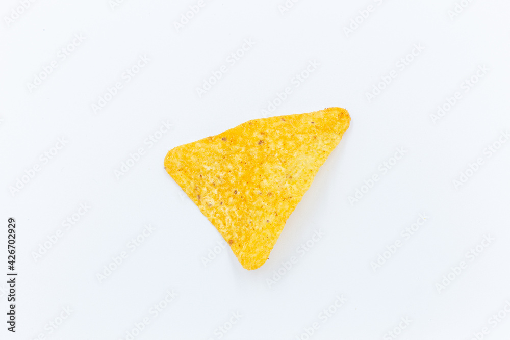 Corn chips into a glass bowl, nachos isolated on white background with copy space Corn chips into a glass bowl, nachos isolated on white background with copy space