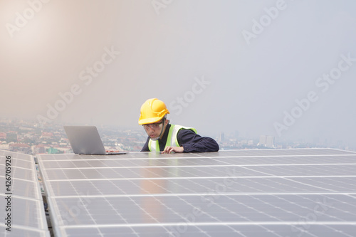 Asian engineer for solar panel inspection roof construction. Engineer worker installing solar panels outdoors