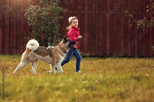 Girl playing in the summer with her dog