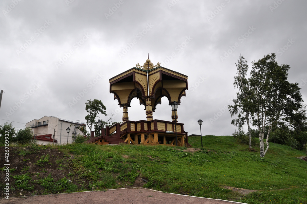Panoramic view of a wooden gazebo, birch trees. Cloudy summer day. Panoramic view of a wooden gazebo, birch trees. Cloudy summer day.