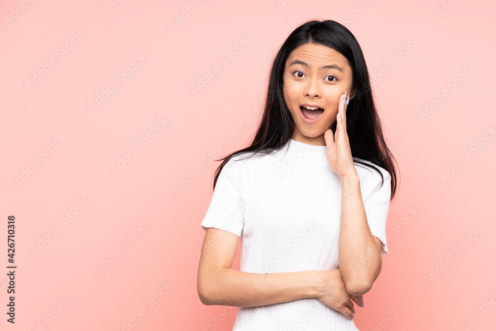 Teenager Chinese woman isolated on pink background with surprise and shocked facial expression Teenager Chinese woman isolated on pink background with surprise and shocked facial expression