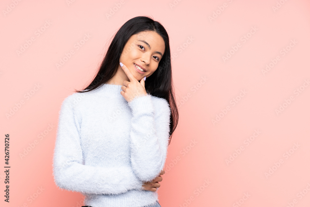 Teenager Chinese woman isolated on pink background happy and smiling Teenager Chinese woman isolated on pink background happy and smiling