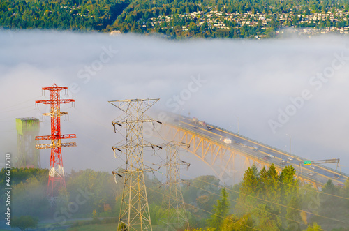 Iron Workers Memorial Second Narrow Bridge is shown in a fog by the shined sunlight , Vancouver, Canada. photo