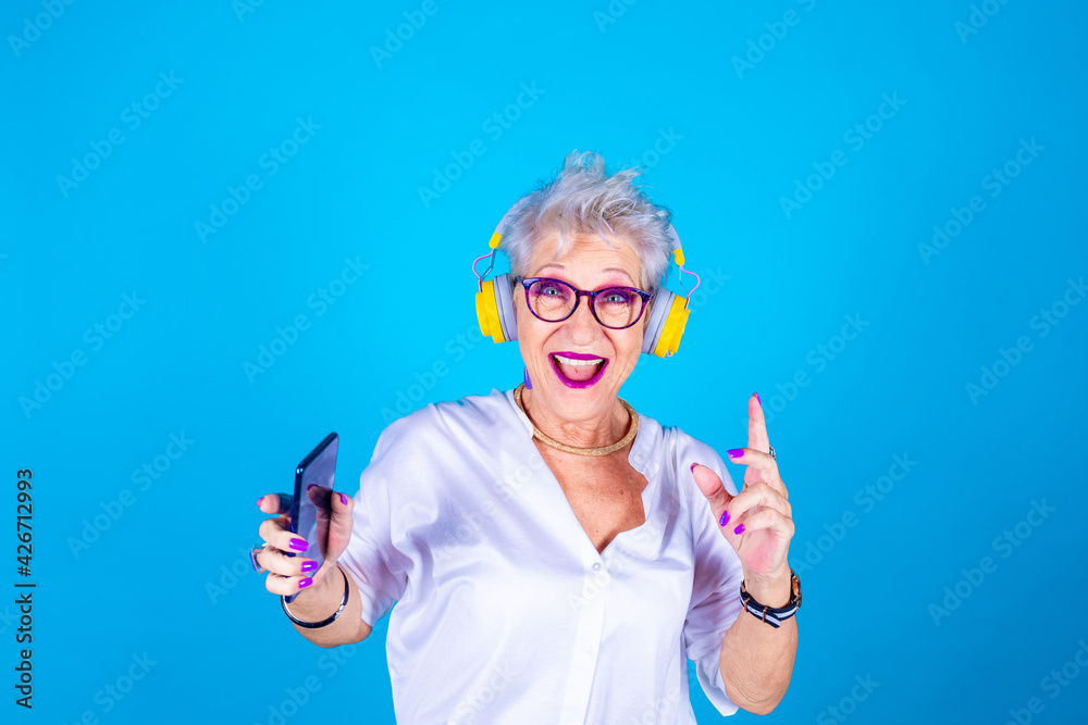 Senior grandmother woman enthusiastic dancing listening music