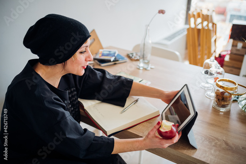 Adult caucasian woman indoors at home watching streaming