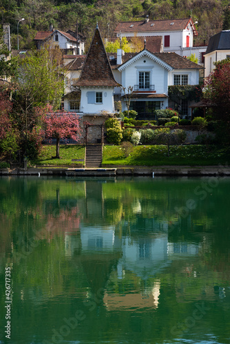 Scenic springtime view of houses at Marne river (Boucles de Marne) in Val-de-Marne department of Ile-de-France. Beautiful reflection.