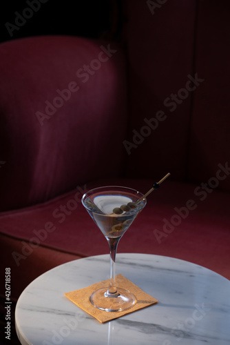 Dry Martini cocktail, with gin and vermut dry; garnished with olive; happy hours at home, homemade drink. Low key