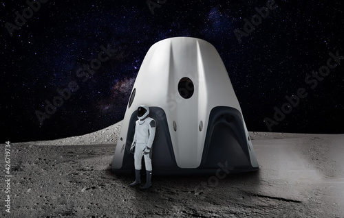 Futuristic theme of an astronaut on a space mission landing on a planet. Elements of this image furnished by NASA. photo