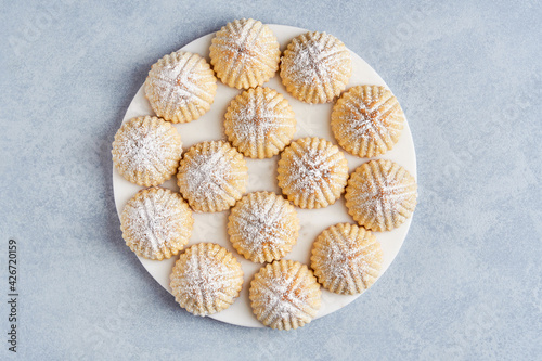Arabic sweets. Traditional eid semolina maamoul or mamoul cookies with dates , walnuts and pistachio nuts .  Top view